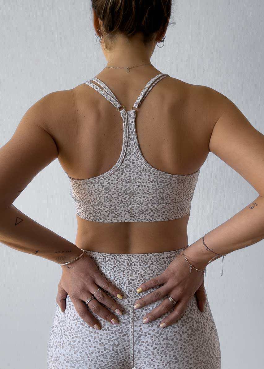 Sujetador diseñado para deportes de impacto medio a bajo con un estilo clásico de cuello redondo, escote en v en la espalda y correas ajustables.  El diseño de este estampado está inspirado sutilmente en el camuflaje de la naturaleza. Siéntete cómoda usando este top en tus entrenamientos de gimnasio, yoga, pilates, trekking o para tu día a día. Combínalo con los leggings Fauna ¡o con lo que quieras!